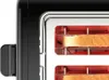 A close-up view of a black toaster with two slices of bread inside. Produktbild-Vorschau