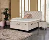 A bedroom scene featuring a bed, nightstand, and decorative items. Produktbild-Vorschau