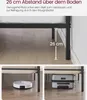 The image shows the underside of a bed frame, highlighting the space underneath for storage and cleaning with a robot vacuum, and also shows a suitcase fitting under the bed. Produktbild-Vorschau