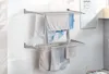 A wall-mounted drying rack with laundry hanging on it. Produktbild-Vorschau