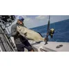 A man holding a large fish on a boat. Produktbild-Vorschau