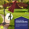 A garden umbrella shown in a yard with text overlays highlighting its features. Produktbild-Vorschau