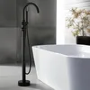 A modern bathroom with a freestanding bathtub and a black floor-mounted faucet. Produktbild-Vorschau
