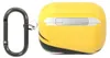 A yellow AirPods case with a black and white stripe design and a carabiner clip attached. Náhľad obrázku produktu