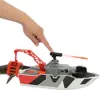 A hand is pressing a button on a toy boat with a dinosaur attached. Náhľad obrázku produktu
