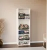 A white shelving unit filled with folded clothes and a duffel bag, placed against a light beige wall. Produktbild-Vorschau