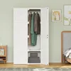A white wardrobe with clothes hanging inside and storage boxes on the bottom shelf, set in a bedroom with a bed and artwork on the wall. Náhled obrázku produktu