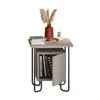 A modern nightstand with decorative items on top and books inside. Produktbild-Vorschau