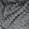 A close-up view of a textured gray blanket. Produktbild-Vorschau