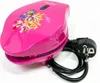 A pink waffle maker with Paw Patrol characters printed on it, shown on a white background with its power cord and plug. Náhled obrázku produktu