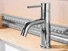A chrome faucet is shown on a marble countertop with a decorative mirror frame in the background. Podgląd zdjęcia produktu