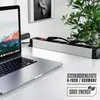A laptop and a power strip on a desk with a plant in the background. Voir les images du produit