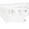 Close-up view of a white wooden children's bed with a moon cutout on the side panel and a hinged door. Anteprima dell’immagine prodotto