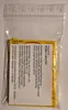 A close-up view of a small, sealed plastic bag containing a package of Wrigley's Juicy Fruit gum. Produktbild-Vorschau