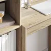 A close-up view of a wooden desk with books and a laptop. Náhled obrázku produktu