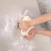 Hands kneading dough on a stainless steel surface. Produktbild-Vorschau