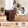 A woman is pushing a foldable dining table with wheels in a room. Náhľad obrázku produktu