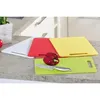 Four cutting boards in different colors are arranged on a kitchen countertop. Produktbild-Vorschau