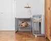 A nursery room with a changing table and a crib. Produktbild-Vorschau