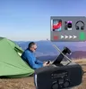 A man sits in a tent in a mountainous landscape, using a solar-powered radio with a built-in flashlight. Produktbild-Vorschau