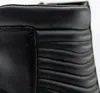 A close-up view of the top section of a black leather boot, showing stitching and quilted detailing. Podgląd zdjęcia produktu