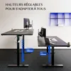 Two adjustable desks with monitors and laptops on them. Voir les images du produit