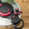 Close-up of a pressure cooker lid with safety lock indicators. Podgląd zdjęcia produktu