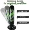 An inflatable punching bag with a dinosaur design, shown with motion blur to indicate it bounces back. Text overlays highlight its features. Produktbild-Vorschau