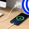 A smartphone is charging on a wooden desk next to a computer keyboard and monitor. Anteprima dell’immagine prodotto