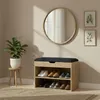 A shoe cabinet with a padded seat is shown in a room with a plant and a mirror. Podgląd zdjęcia produktu