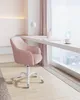 A pink office chair in front of a desk by a window. Náhled obrázku produktu