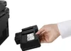 A hand is shown inserting a black ink cartridge into a printer. Produktbild-Vorschau