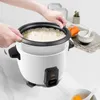 Hands operating a rice cooker with cooked rice. Produktbild-Vorschau