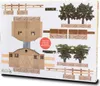 A flat lay of a model farm set with trees, fences, and buildings, likely a toy or model kit. Podgląd zdjęcia produktu