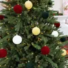 A close-up shot of a decorated Christmas tree with various ornaments. Voir les images du produit