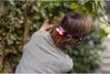 A person wearing a headlamp while tending to plants. Produktbild-Vorschau