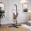 A modern living room with a hanging chair, artwork, and a floor lamp. Náhled obrázku produktu