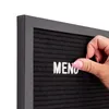 A hand is placing a white letter 'U' onto a black felt letter board, with the word 'MENU' partially visible. Produktbild-Vorschau