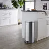 A modern kitchen with white cabinets and a stainless steel trash can. Produktbild-Vorschau