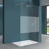 A modern walk-in shower enclosure with a frosted glass panel, installed in a bathroom with blue walls and a concrete floor. Produktbild-Vorschau