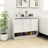A white sideboard with three doors and an open shelf below, decorated with plants and picture frames, placed in a room with light wooden flooring. Anteprima dell’immagine prodotto