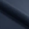 A close-up view of dark blue fabric, likely a mattress or bedding material, with a fold creating a shadow. Produktbild-Vorschau