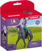 A toy horse and rider set in its packaging, set against a grassy field background. Voir les images du produit
