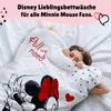A person is tucked into a duvet with a Minnie Mouse design. Produktbild-Vorschau