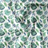 A flat lay of a fabric with a repeating pattern of green and blue tropical leaves. Náhled obrázku produktu