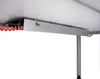 A close-up view of the underside of a desk, showing a metal cable management tray with a red coiled cable. Anteprima dell’immagine prodotto