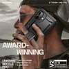 A person holding a black phone case in front of a blurred outdoor background. Produktbild-Vorschau