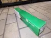 A green and white Lexmark toner cartridge box is lying on a tiled floor. Anteprima dell’immagine prodotto