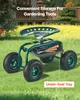 A green gardening seat with wheels and a tool tray, placed on a grassy lawn with a blurred background of a house and yellow flowers. Produktbild-Vorschau
