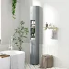 A bathroom scene with a tall, narrow cabinet, a bathtub, and plants. Podgląd zdjęcia produktu